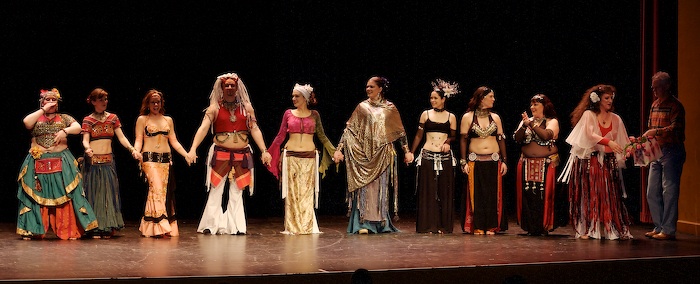 Photo of: Line-up for perfomers at Bloomington Belly Dances - 2007 receiving flowers from Roger Meridith and Margaret Lion during their curtain call.