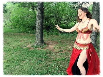 Photo of Anel dancing outside.