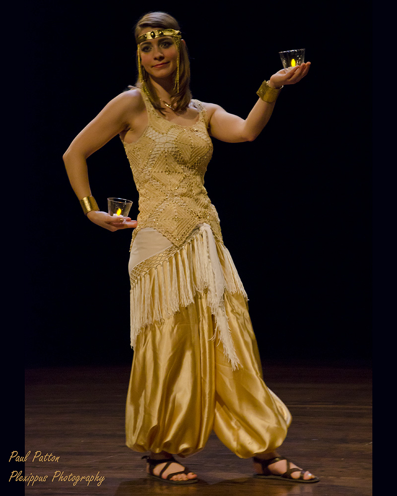 Photo of Carrie performing a candle dance with Banat Mara. Photo taken by Paul Patton. 