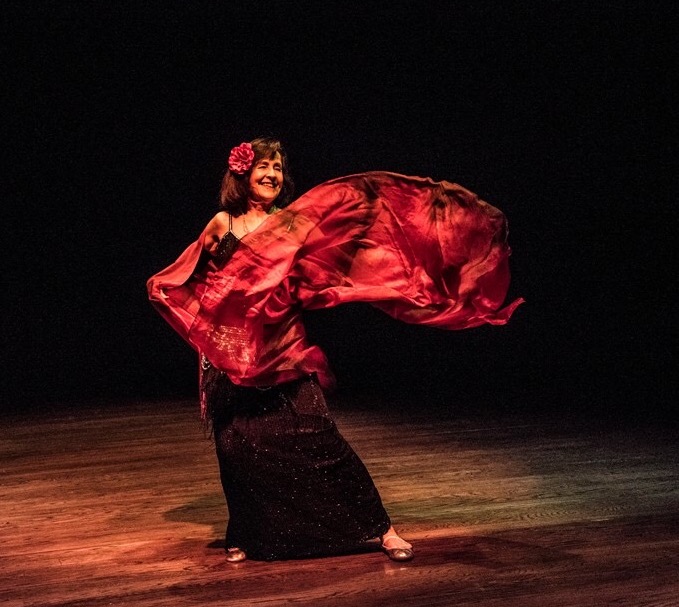 Bette Lucas dancing with a red veil.